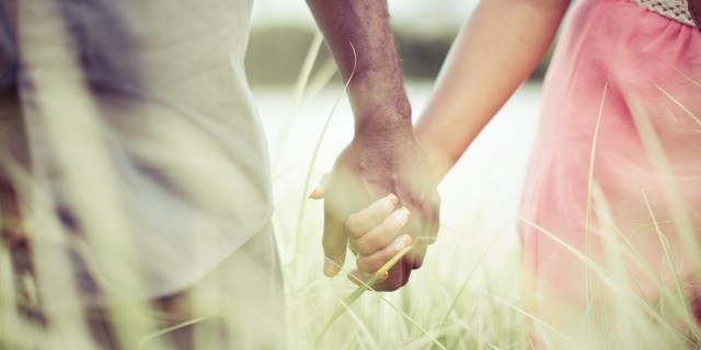 couple-holding-hands-field